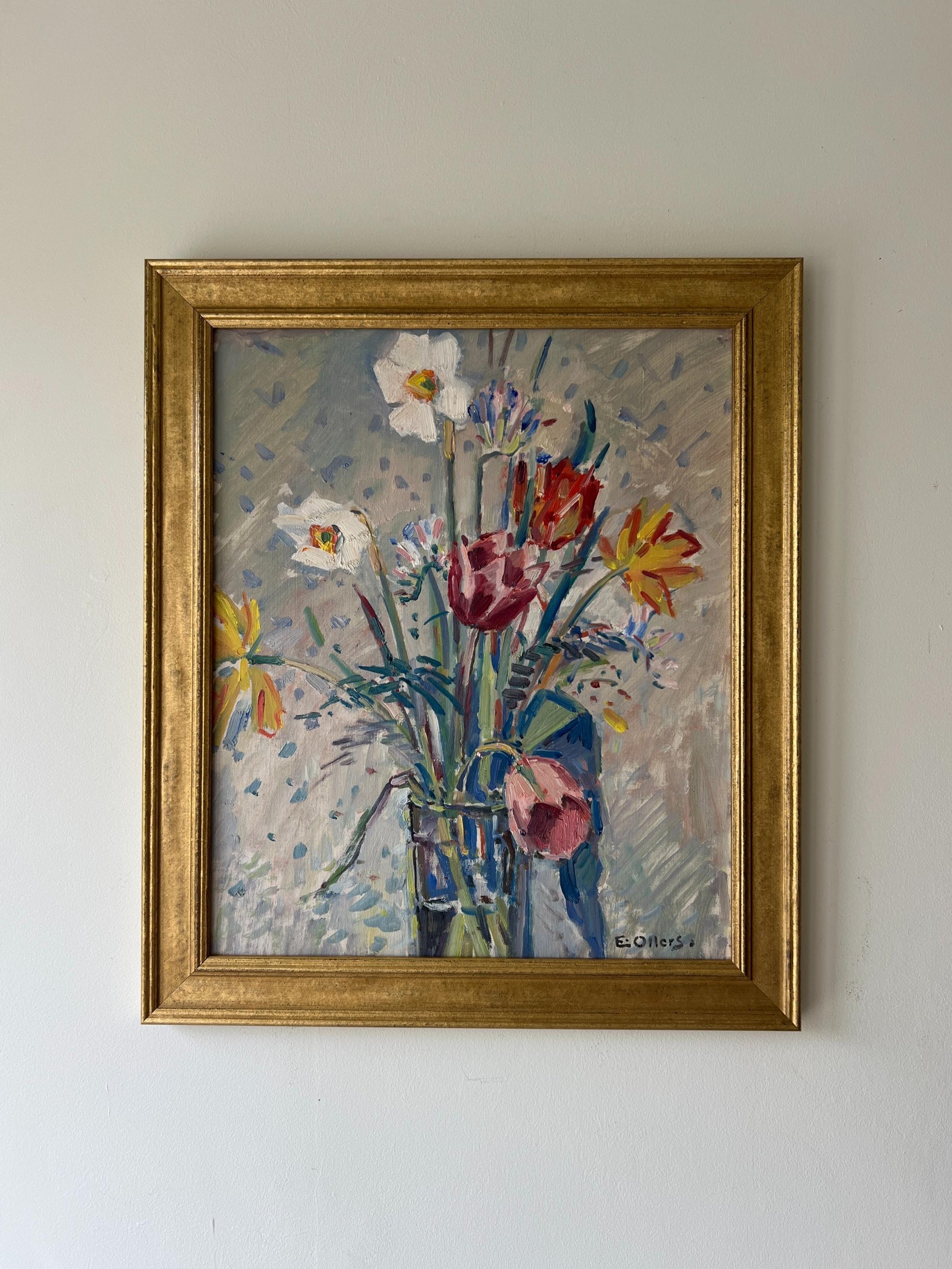A framed vintage oil painting of a spring bouquet in a tall glass vase. Available at Hue. 