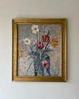 A framed vintage oil painting of a spring bouquet in a tall glass vase. Available at Hue. 