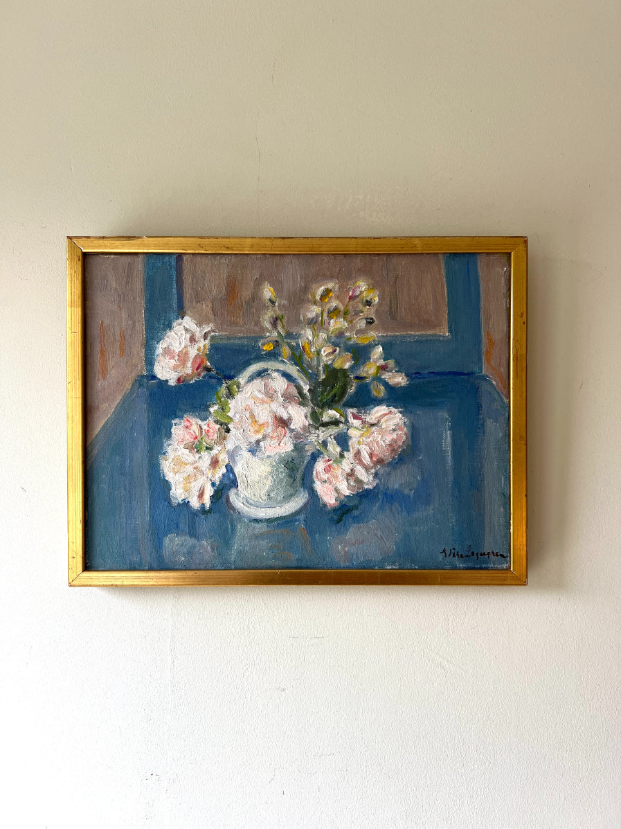 Framed vintage oil painting of pale pink flowers on a blue table. Available at Hue. 