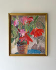 A framed vintage oil painting of a sill life bouquet of red flowers in a terracotta pot. Available at Hue. 