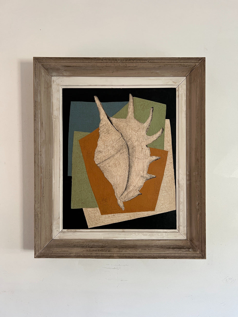 Framed oil artwork with a large shell on a geometric background. Available at Hue.