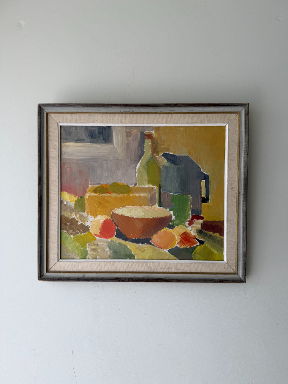 Framed vintage oil still life painting with a blug jug, vessels and fruit. Available at Hue.