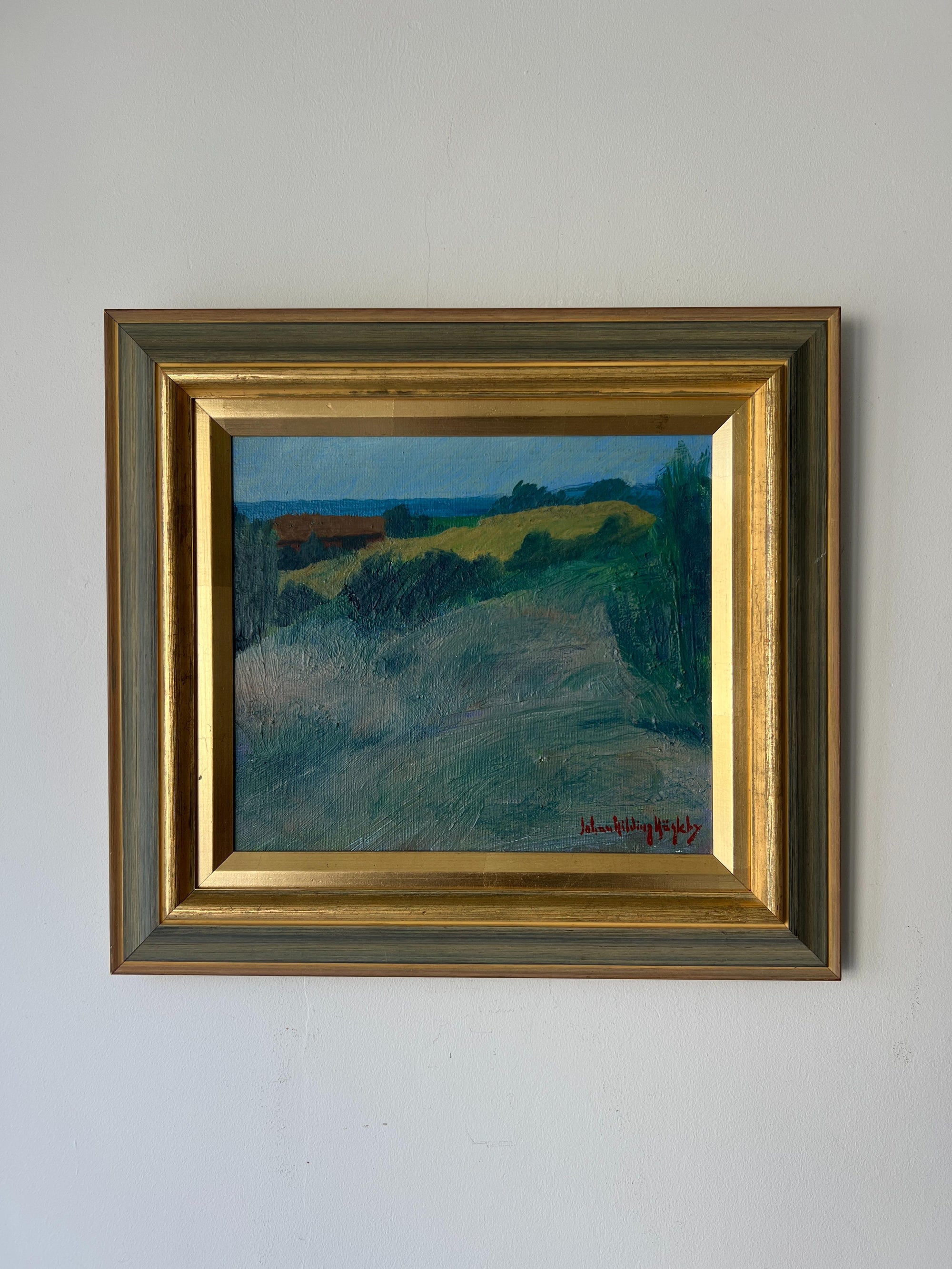 Framed vintage oil painting of a landscape with a gold frame. Available at Hue. 