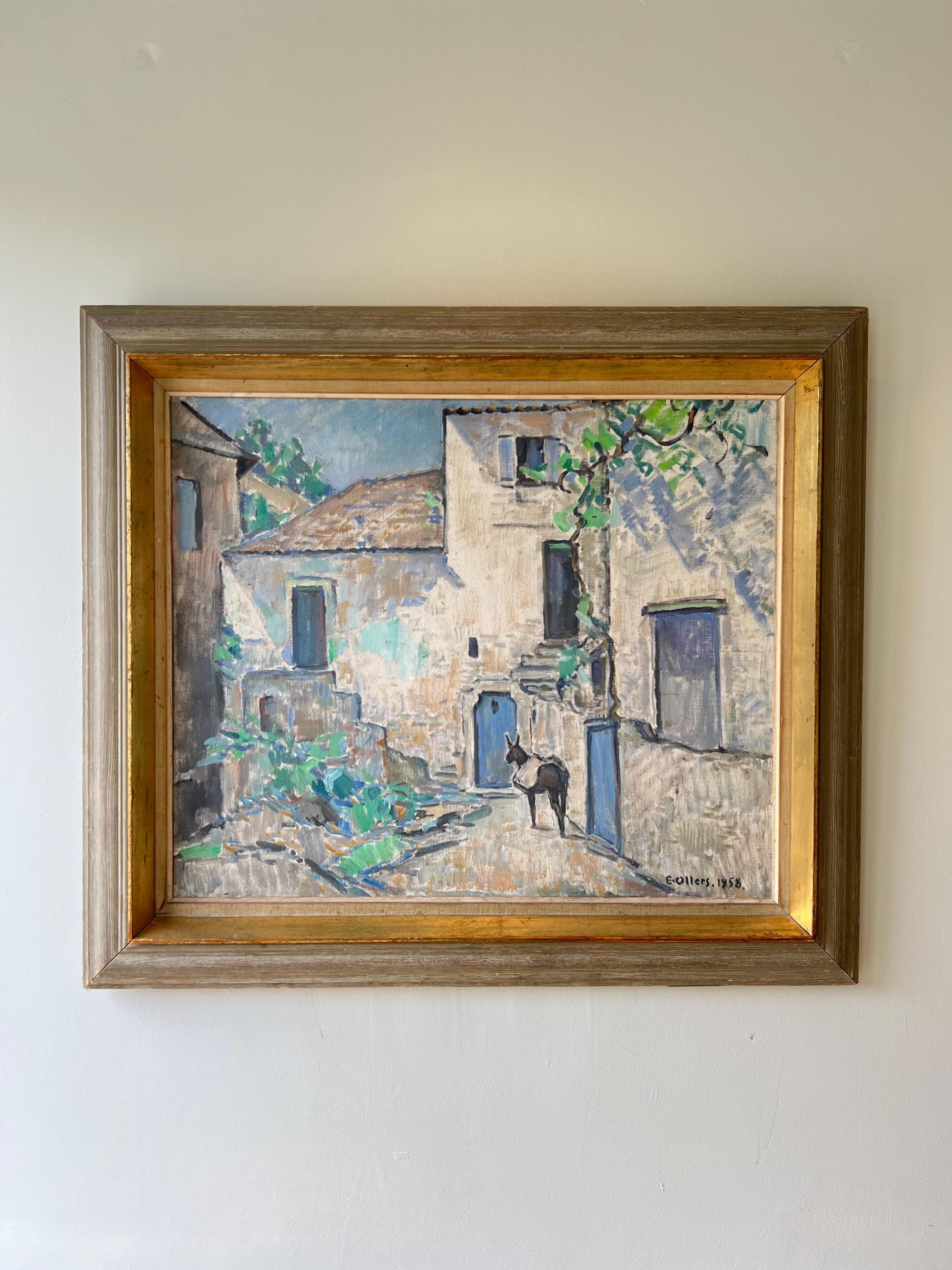 Framed vintage oil painting of a village street scene with buildings and a mule, available at Hue.