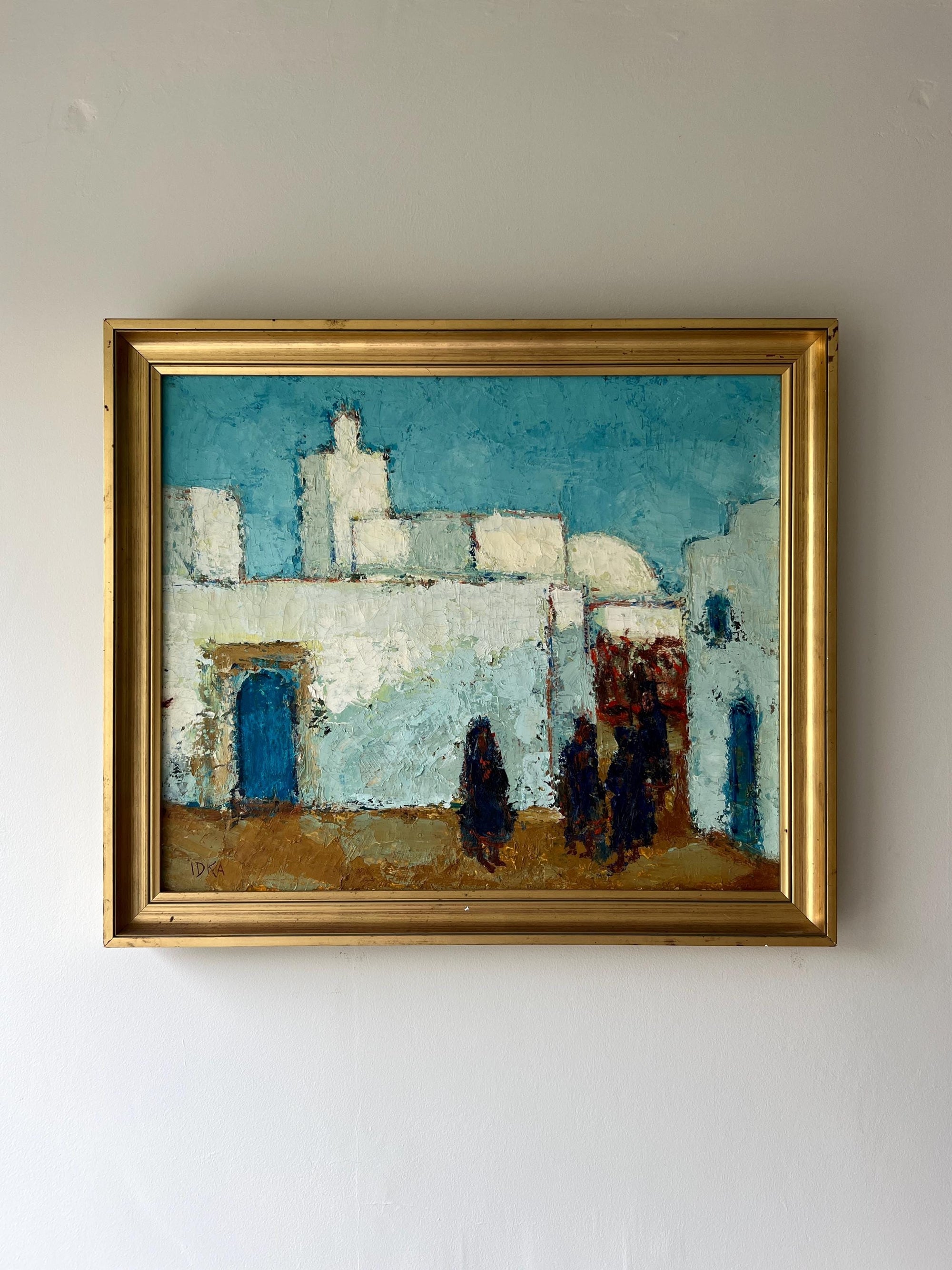 Framed vintage oil painting of a cityscape with whitewashed buildings, available at Hue