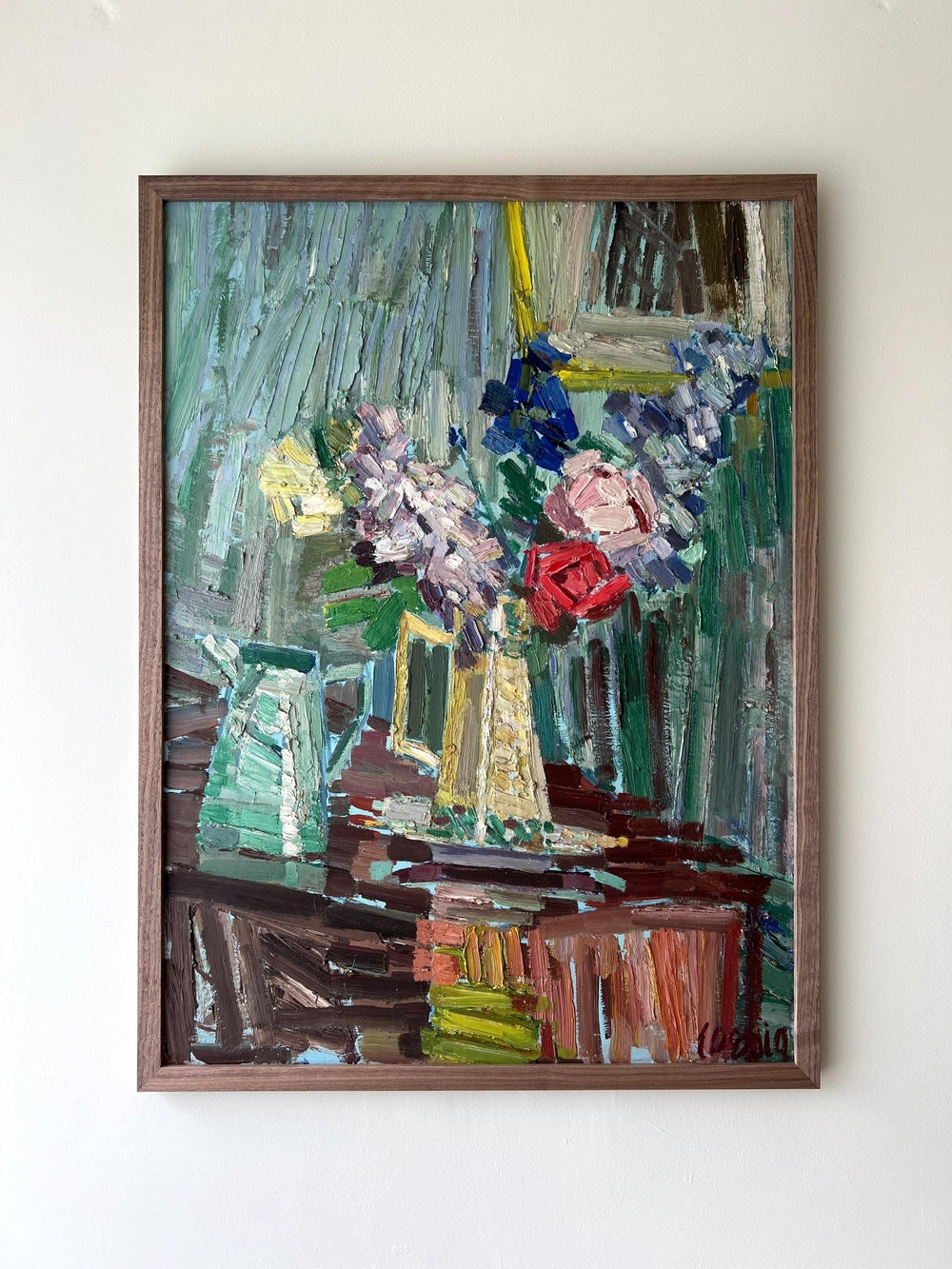 Framed painting of a still life with book, jugs, roses and stocks