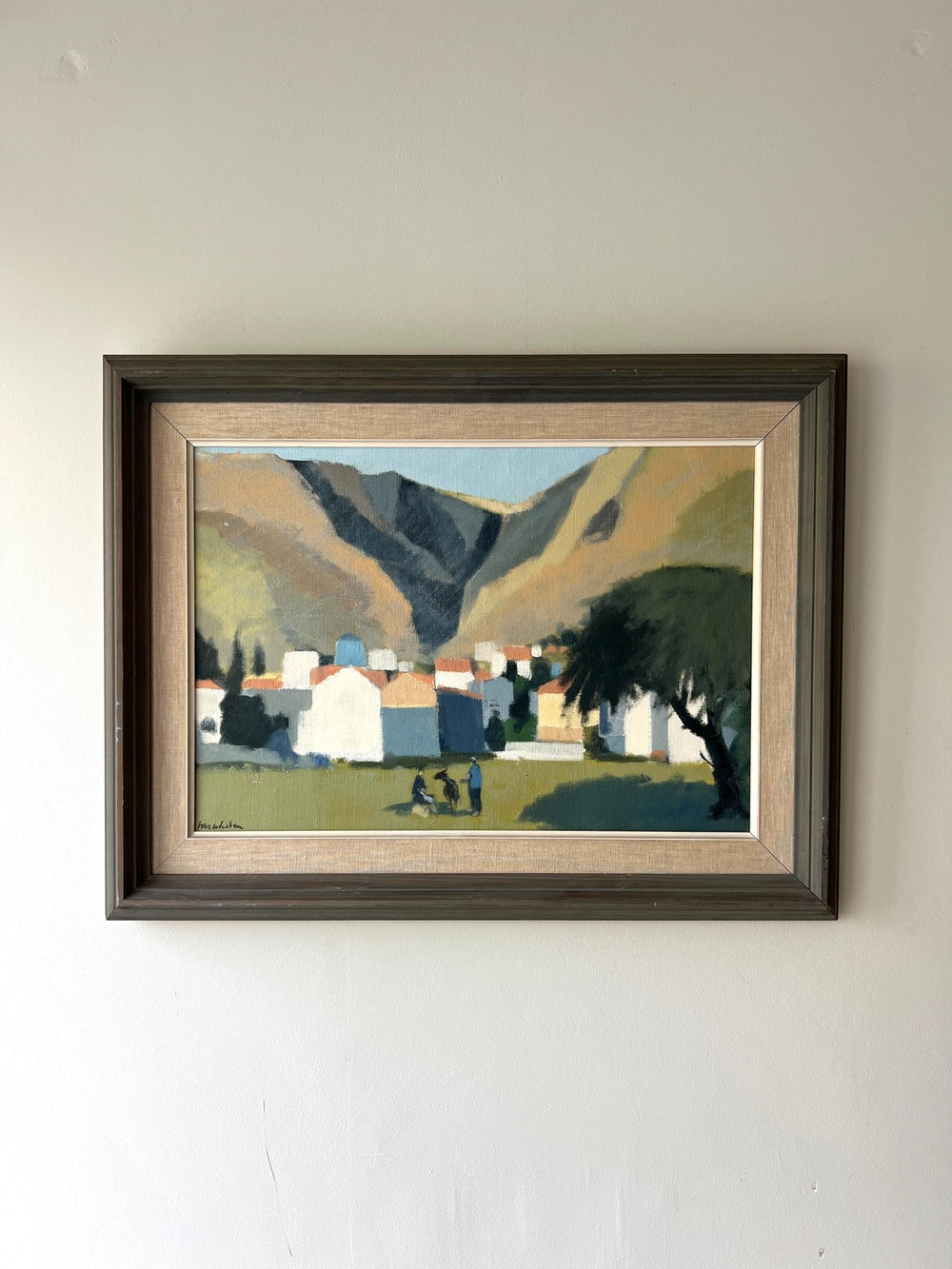 Framed painting of a sunlit mountainous valley landscape with buildings and trees, people and goats, available from hue