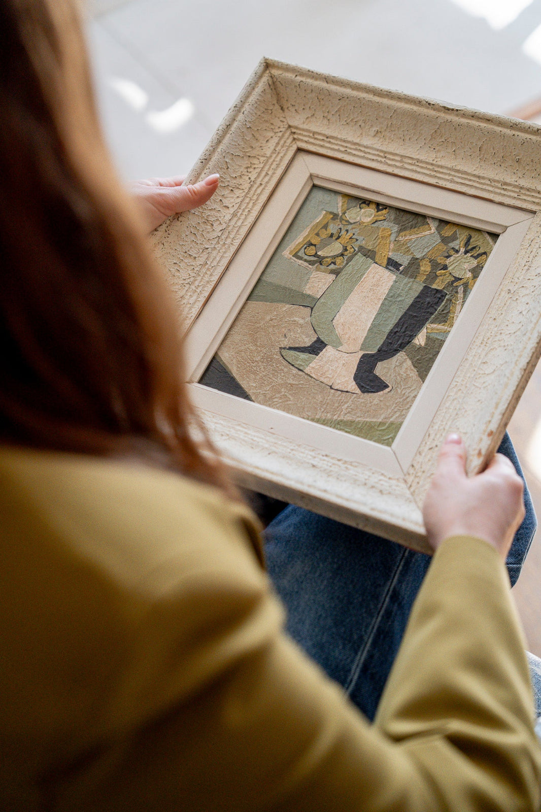 Original French mid-century vintage art featuring a framed abstract stil life painting held by a vintage art curator.