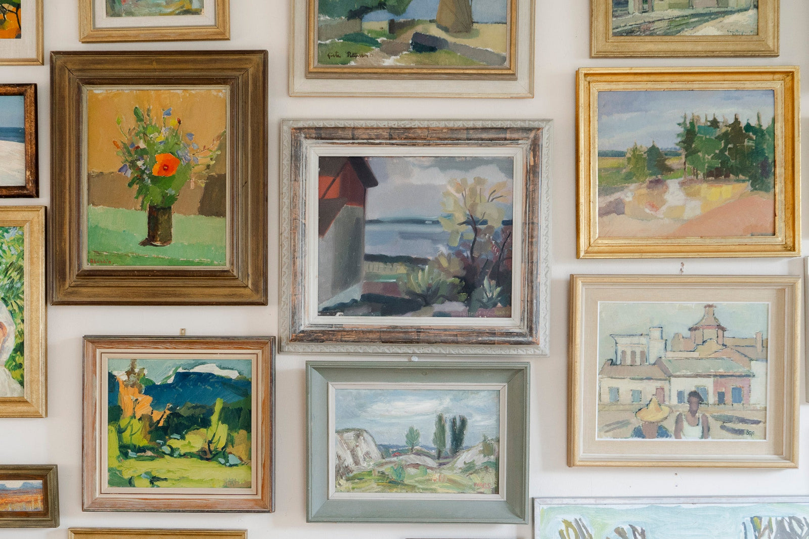Gallery wall featuring Scandinavian vintage art, original vintage oil paintings, landscapes and a floral still life.