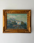 A framed vintage landscape oil painting featuring a mountain, palm trees and coastline, housed in an ornate gold frame. Available at Hue. 