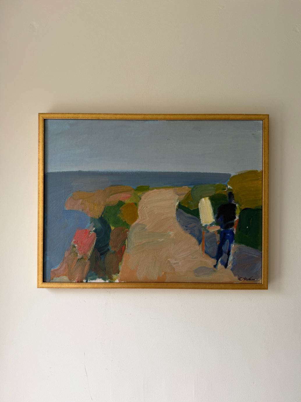 A framed vintage abstract landscape painting. The artwork depicts a coastal scene with blue water, tan and green landforms, and a dark blue figure. Available at Hue. 