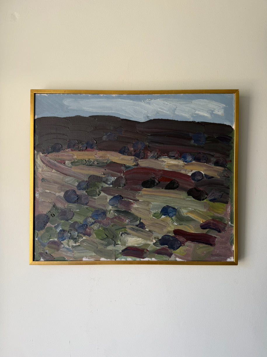 A framed vintage landscape oil painting with thick impasto brushstrokes, featuring dark hills, a pale sky, and earthy fields in purple, brown, green, and red tones. Available at Hue.