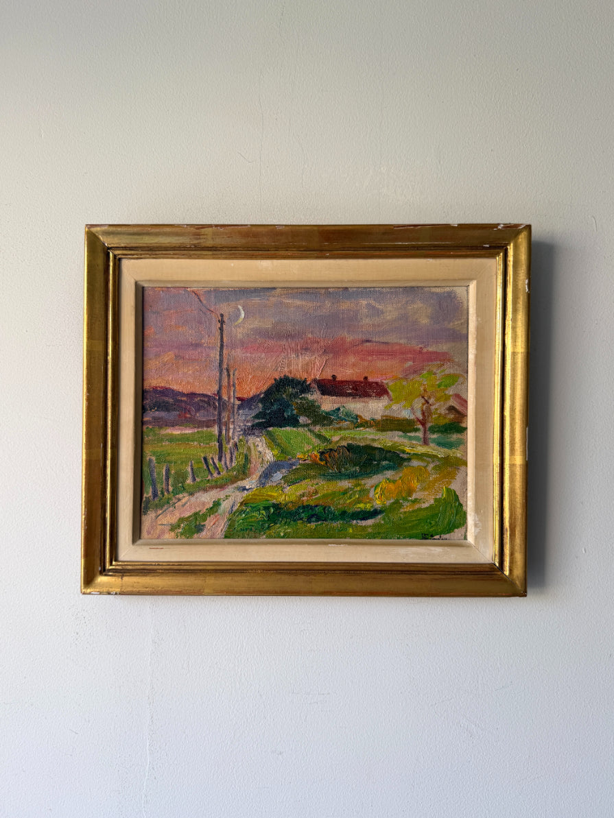 A framed vintage  landscape oil painting. The painting depicts a rural path leading to a house under a pink and purple sky, surrounded by green fields. Available at Hue.