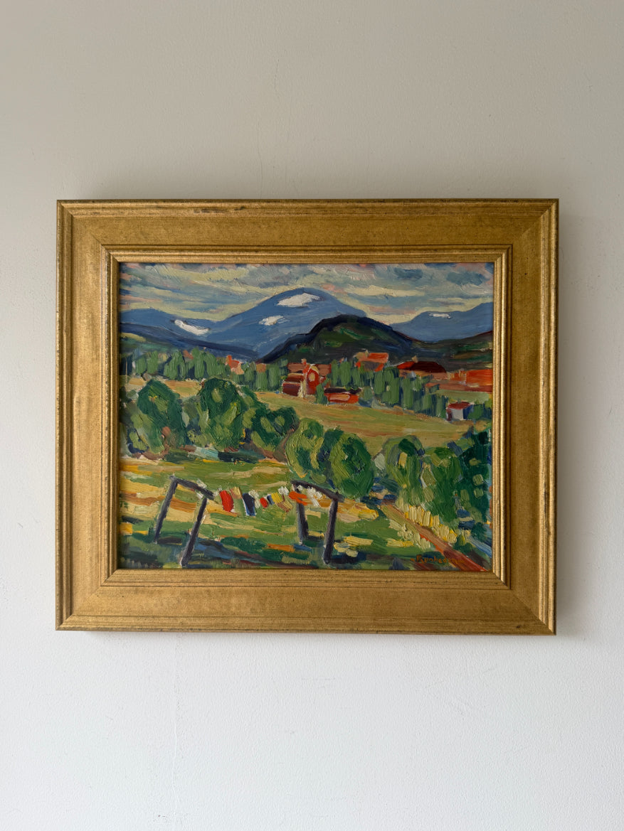 Framed vintage oil painting of a landscape with trees, fields and distant snow-capped mountains and small village settlement. Available at Hue,