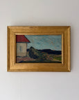 A framed vintage landscape oil painting featuring a white house with a red roof, dark hills, and a blue sky, housed in a gold fram. Available at Hue. 