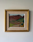 A framed vintage landscape oil painting of rolling hills and vineyards, featuring a rustic gold frame and a textured beige mat board. Available at Hue. 