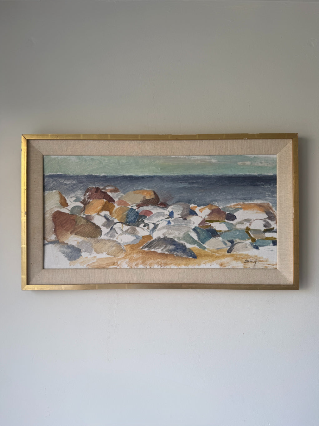 Framed vintage landscape oil painting of a rocky shore. Available at Hue. 