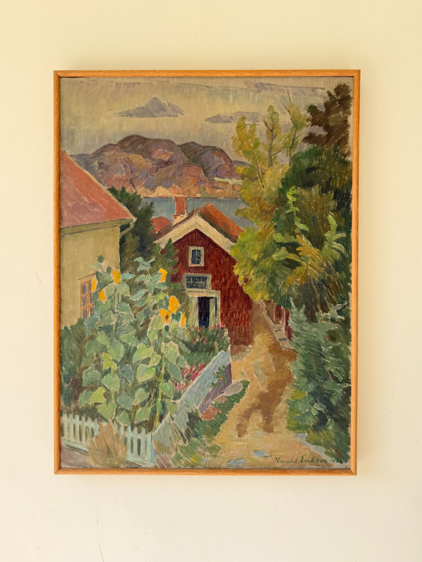 Framed vintage oil painting of a red cottage by the sea with sunflowers and summer vegetation. Available at Hue. 