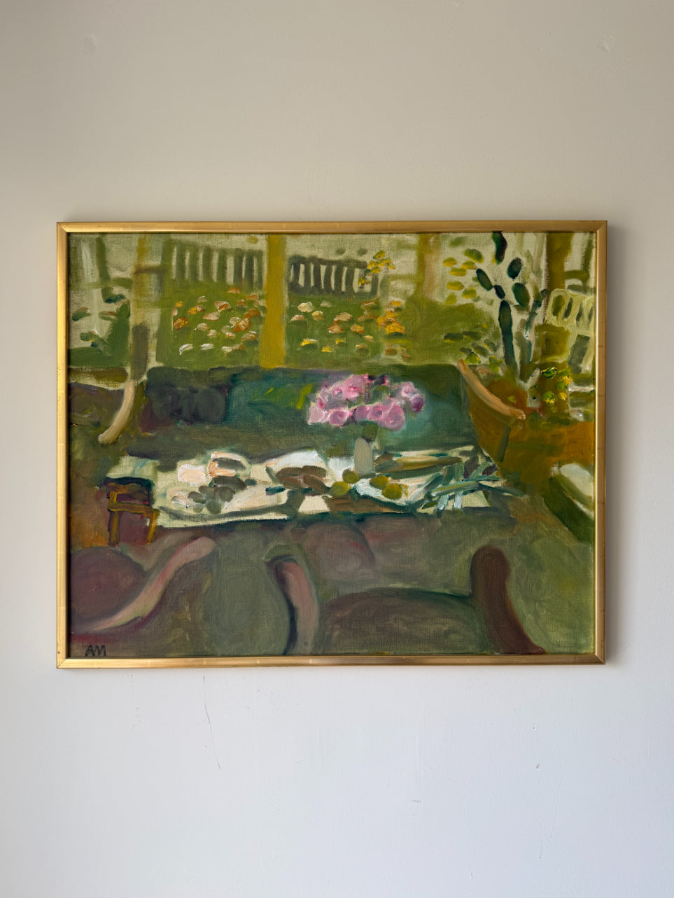 A framed vintage oil painting depicting a semi-abstract still life scene with green foliage, a pink flower arrangement, and a table setting. Available at Hue. 