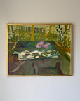 A framed vintage oil painting depicting a semi-abstract still life scene with green foliage, a pink flower arrangement, and a table setting. Available at Hue. 