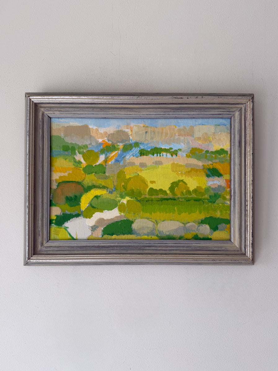 Framed vintage oil painting of a summer landscape with bright greens and yellows. Available at Hue. 