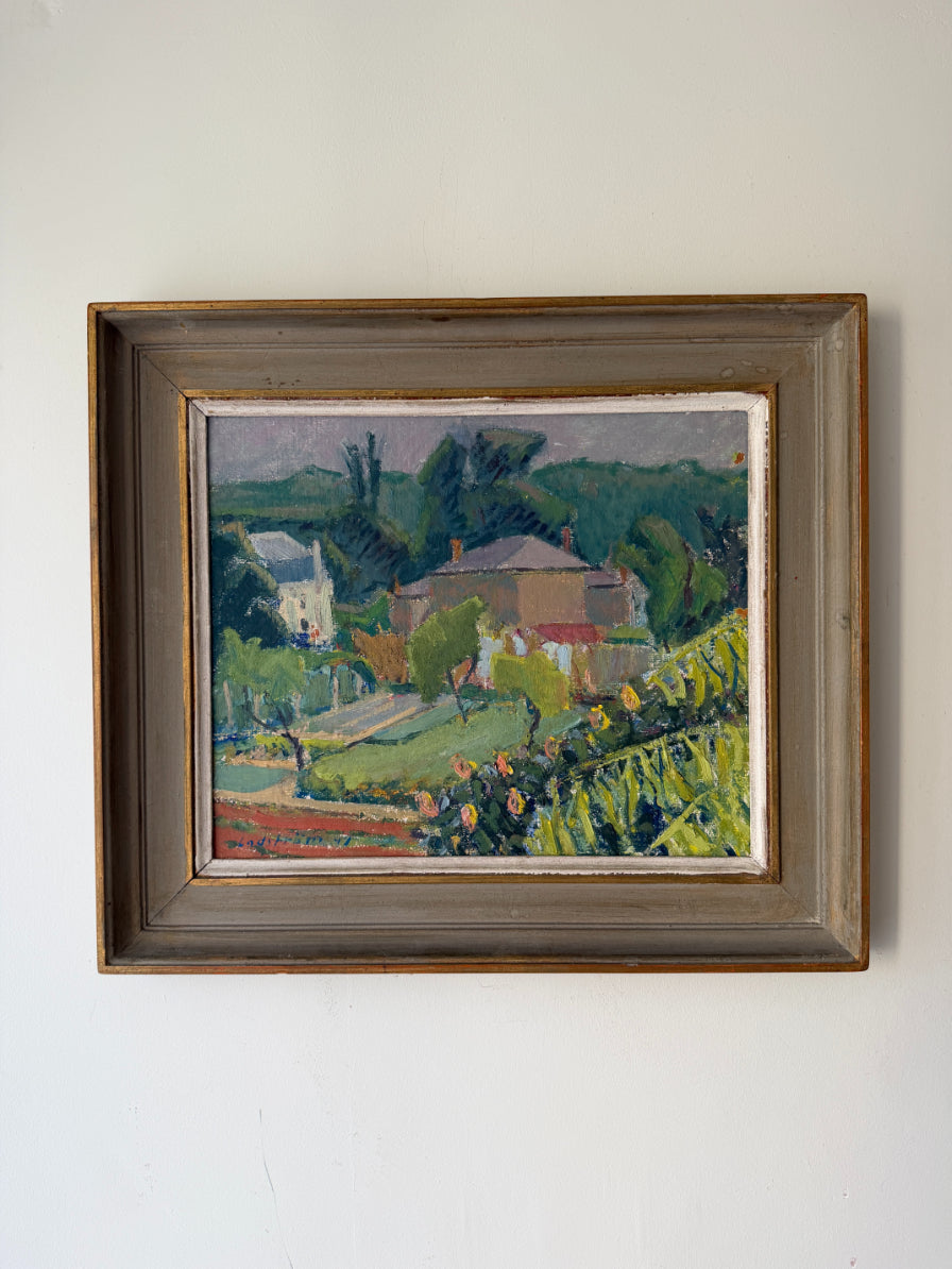 A framed vintage landscape oil painting. The painting depicts mature gardens and a country house, enclosed in a rustic wooden frame. Available at Hue. 