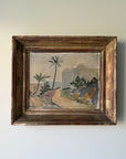 A framed vintage landscape oil painting featuring palm trees, hills, and arches, housed in a rustic dark brown wooden frame. Available at Hue. 