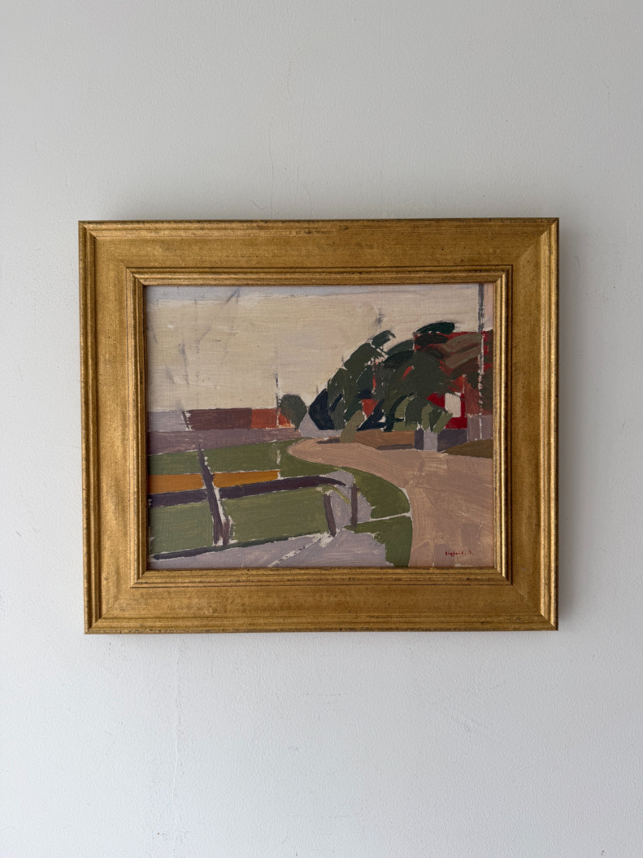 A framed vintage landscape painting on canvas, featuring  green fields, a winding road, and dark trees, housed in a gold frame. Available at Hue. 