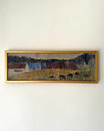 A framed vintage landscape painting featuring stylized houses, trees, and grazing horses, housed in a gold frame. Available at Hue.