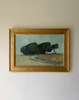 A framed vintage landscape oil painting featuring dark green trees, a small white house, and a winding road, housed in a gold frame. Available at Hue. 