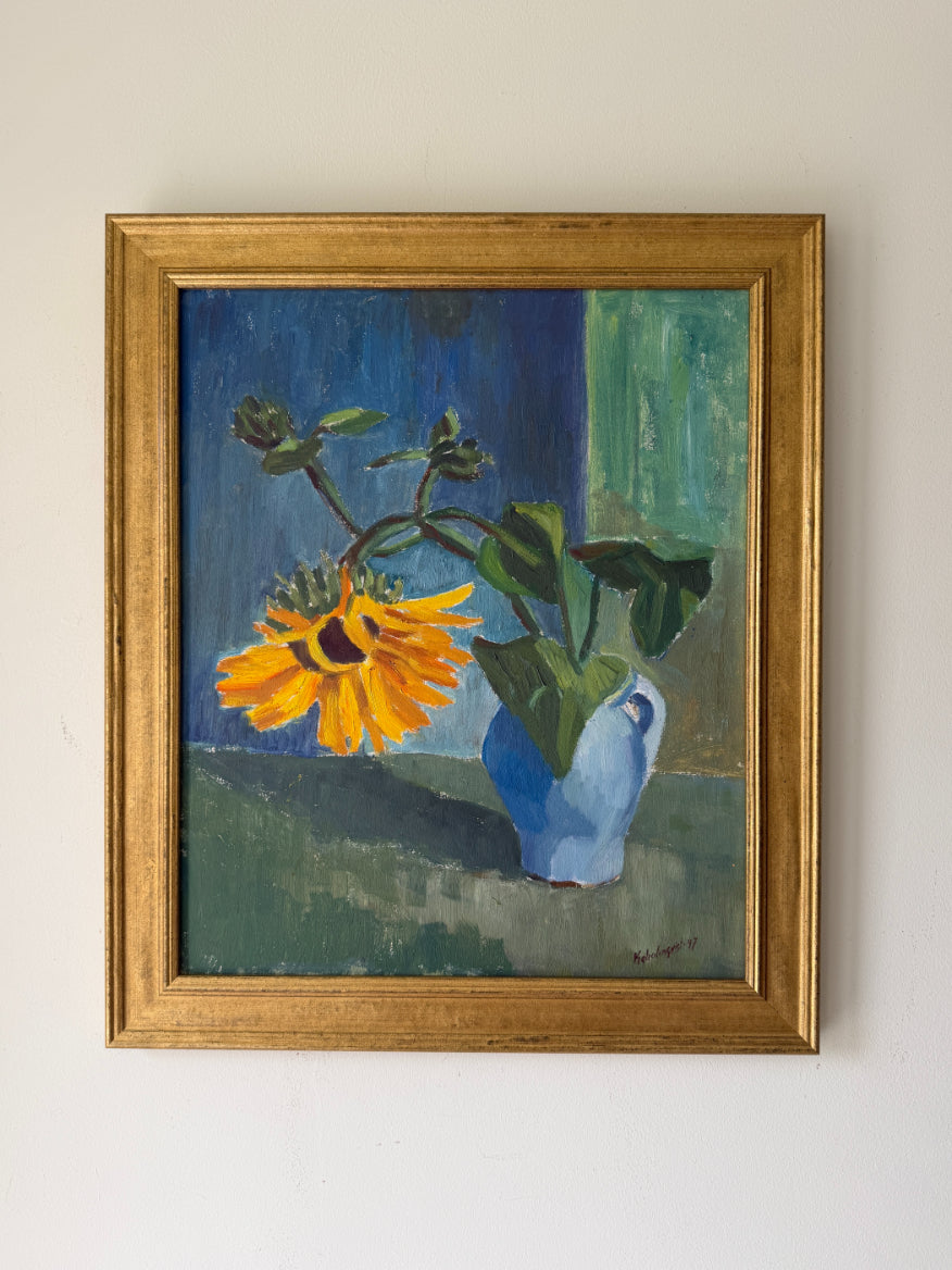 Framed vintage still life oil painting of a sunflower in a  blue vase. Floral art. Available at Hue. 