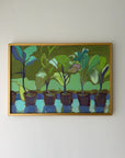 A framed vintage painting depicting a row of potted plants in shades of green, blue, and brown. Available at Hue. 