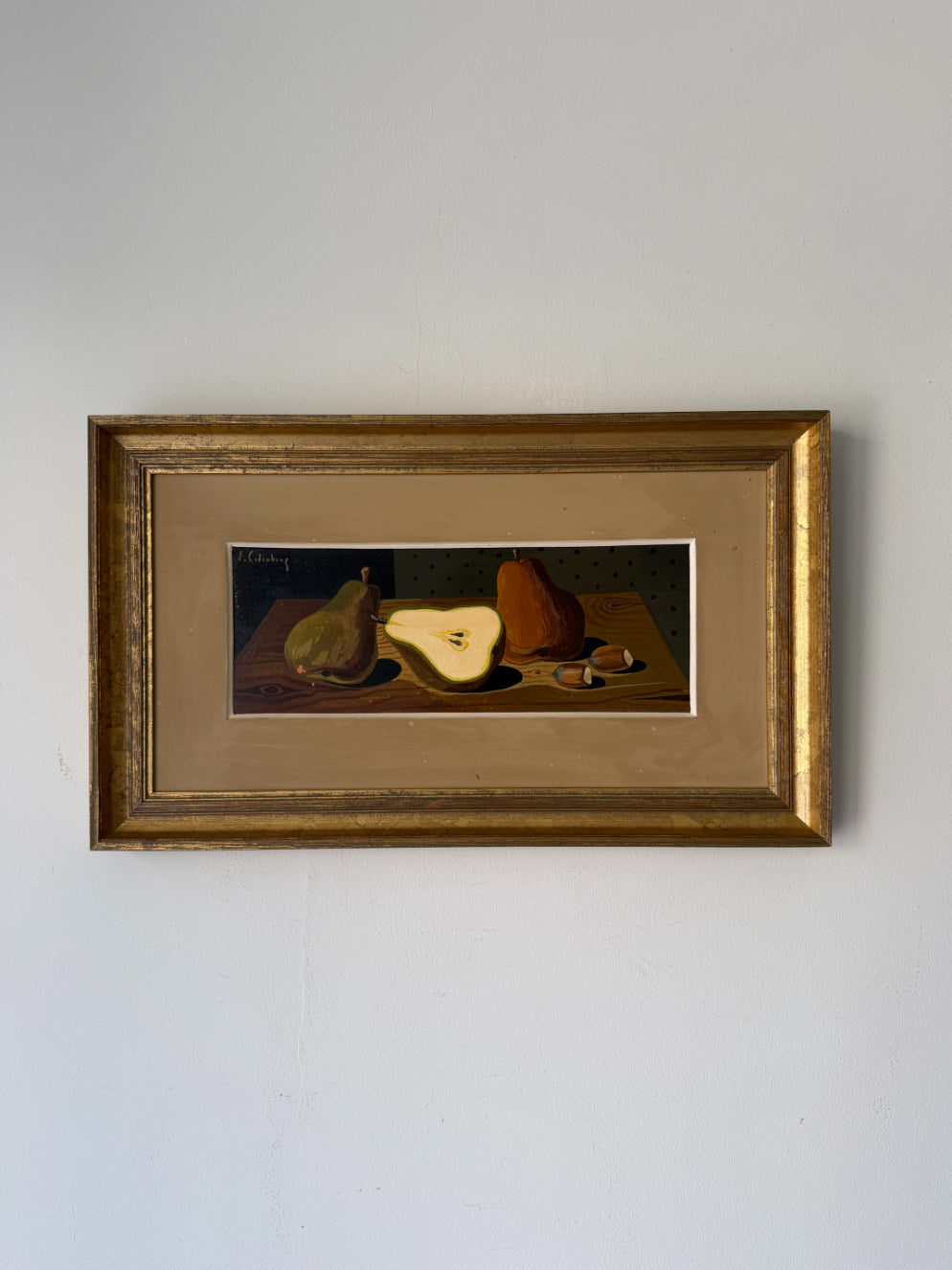 A framed vintage mid-century still life oil painting featuring pears and acorns on a table. Available at Hue. 