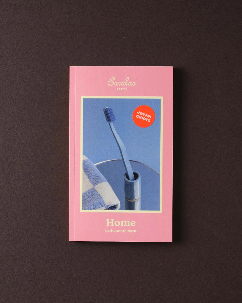 The Sundae Press Home publication cover featuring a blue toothbrush holder and striped textile on a pink background.